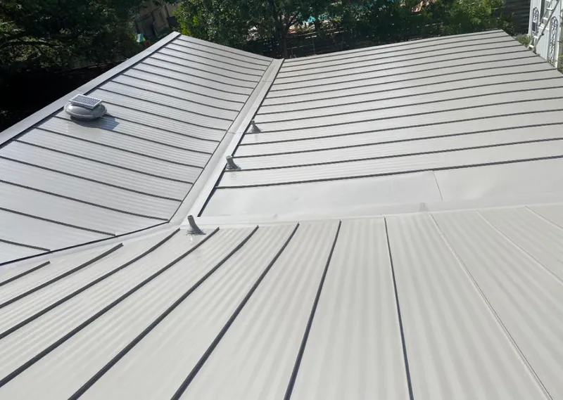 Solar attic fan installed on a metal roof for Roof Ventilation in Sealy